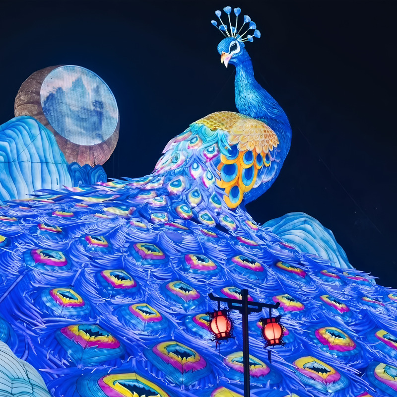 Custom Giant Peacock Zigong Lantern, Large Peacock Spreading Tail Silk Light Sculpture with Mountain & Moon Backdrop, Waterproof Outdoor Festival Light Exhibition